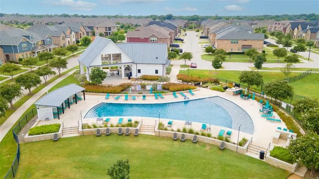 an aerial view of a house with a swimming pool outdoor seating and yard