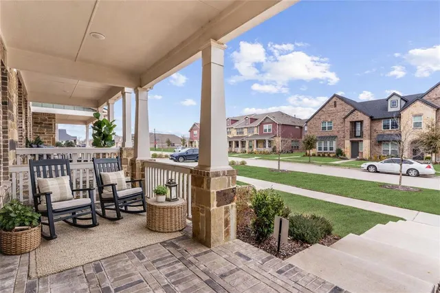 a view of a patio with couches and table and chairs and potted plants