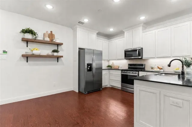 a kitchen with a refrigerator and a sink