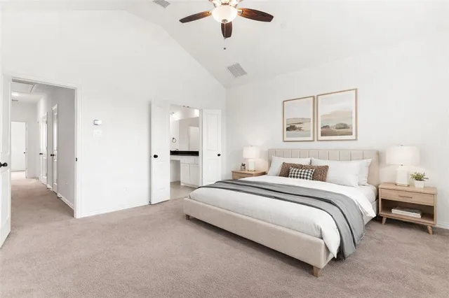 a spacious bedroom with a bed and a chandelier