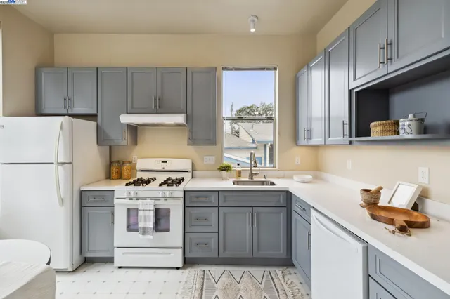 a kitchen with a sink a stove and cabinets