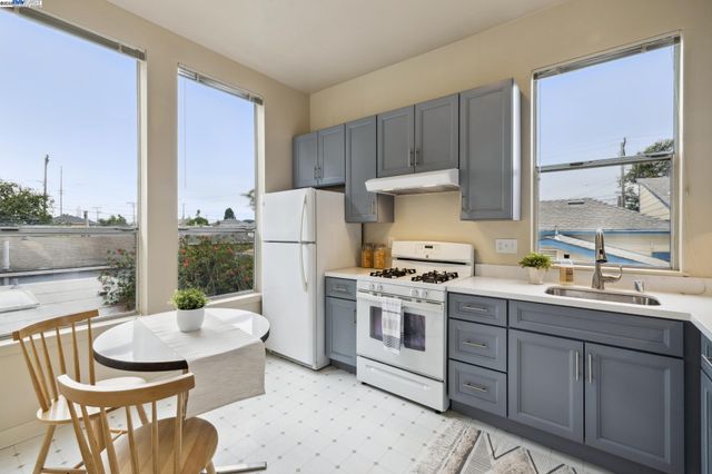 a kitchen with a stove a sink and a refrigerator