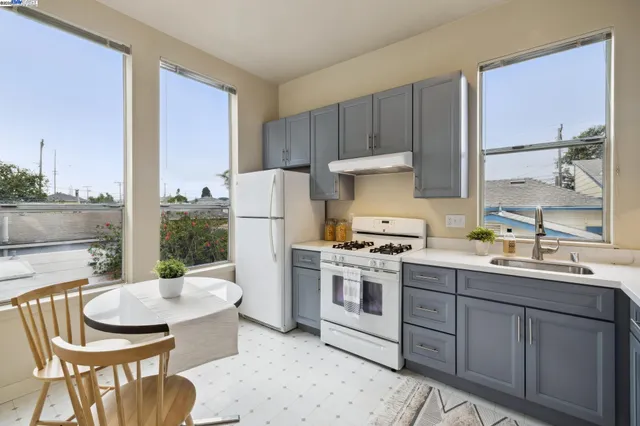 a kitchen with a stove a sink and a refrigerator