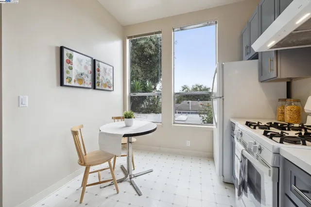 a kitchen with a stove sink and cabinets