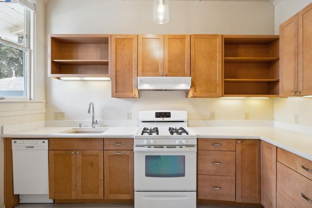 a kitchen with a sink stove and cabinets