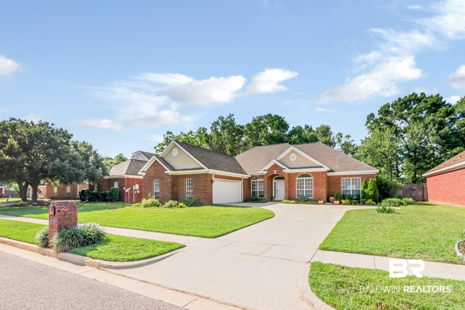 8520 Gayla Court Mobile, AL 36695 - Photo 39 of 40 Traditional brick residence featuring a two-car garage, a concrete driveway, and a gabled roofline
