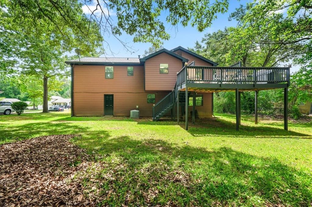 2561 Ripple Way Lawrenceville, GA 30043 - Photo 19 of 19 a view of a house with backyard and a tree