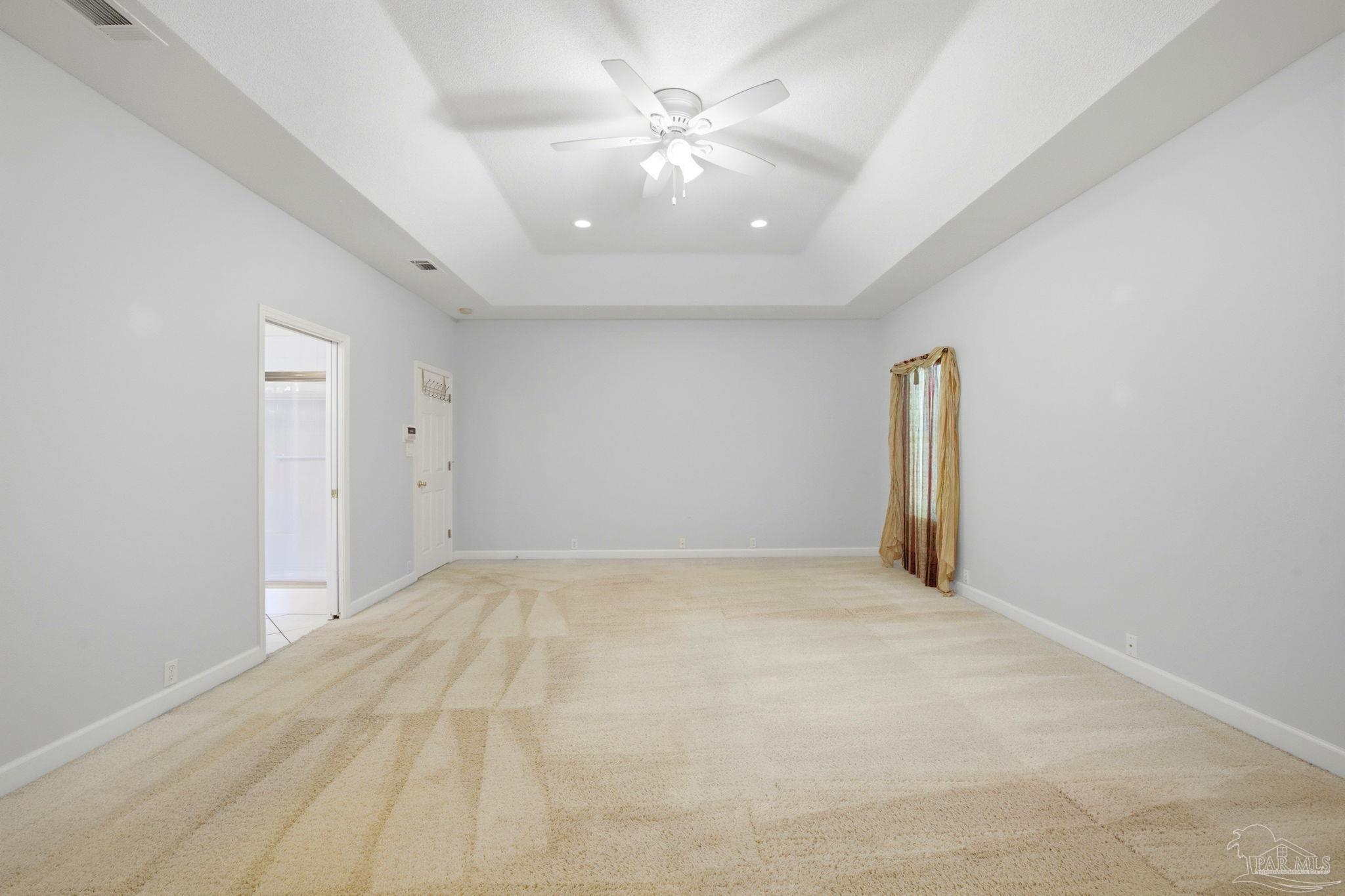 4552 Peaden Road Pace, FL 32571 - Photo 25 of 38 an empty room with chandelier fan and windows