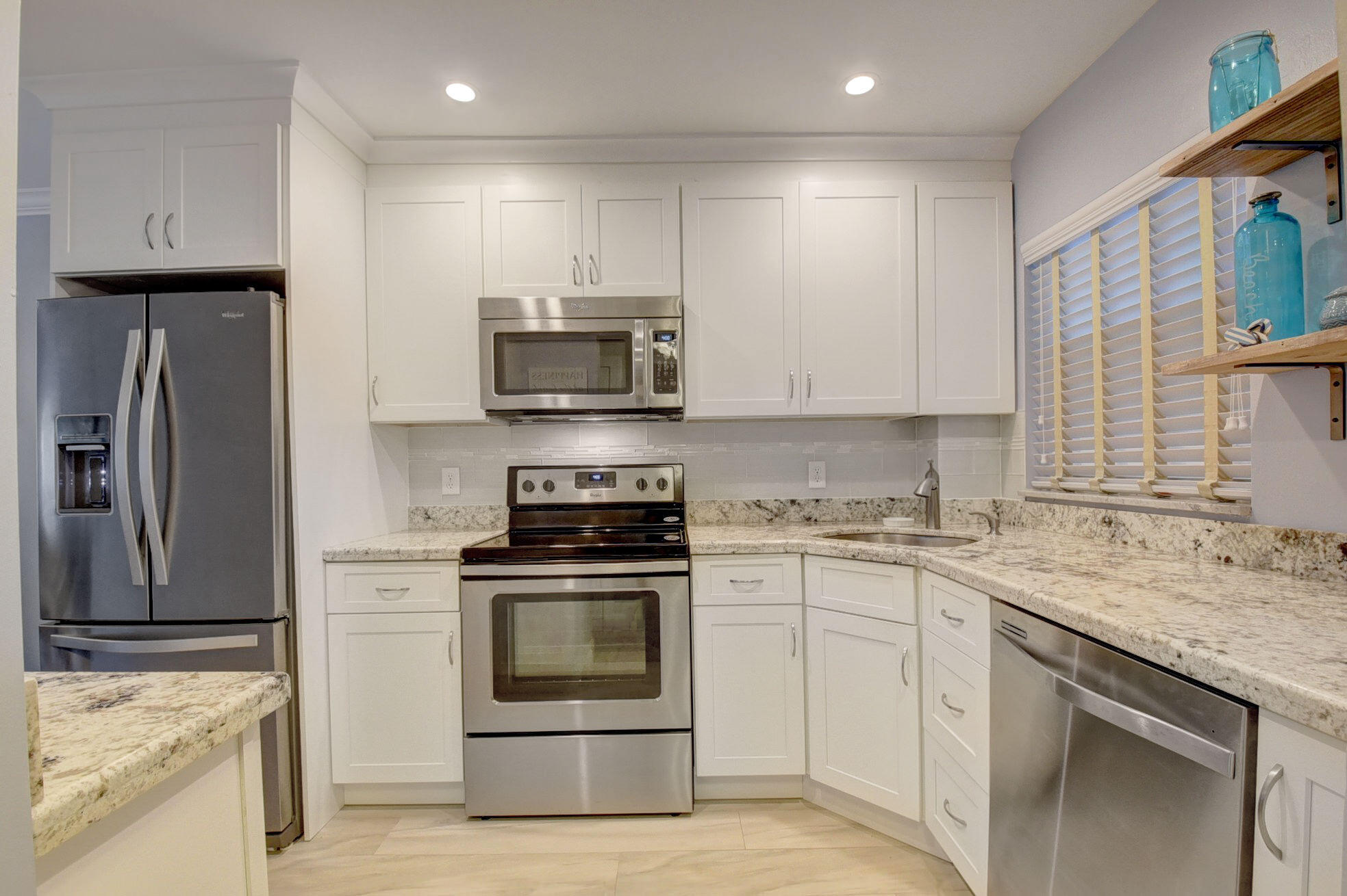 650 Snug Harbor Drive, Unit G307 Boynton Beach, FL 33435 - Photo 1 of 58 a kitchen with a sink stove and refrigerator