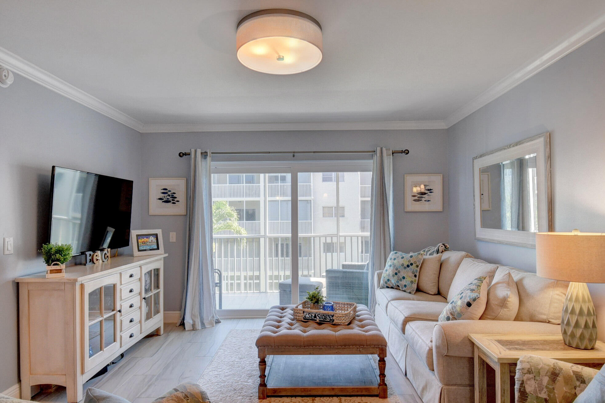 650 Snug Harbor Drive, Unit G307 Boynton Beach, FL 33435 - Photo 11 of 58 a living room with furniture and a flat screen tv