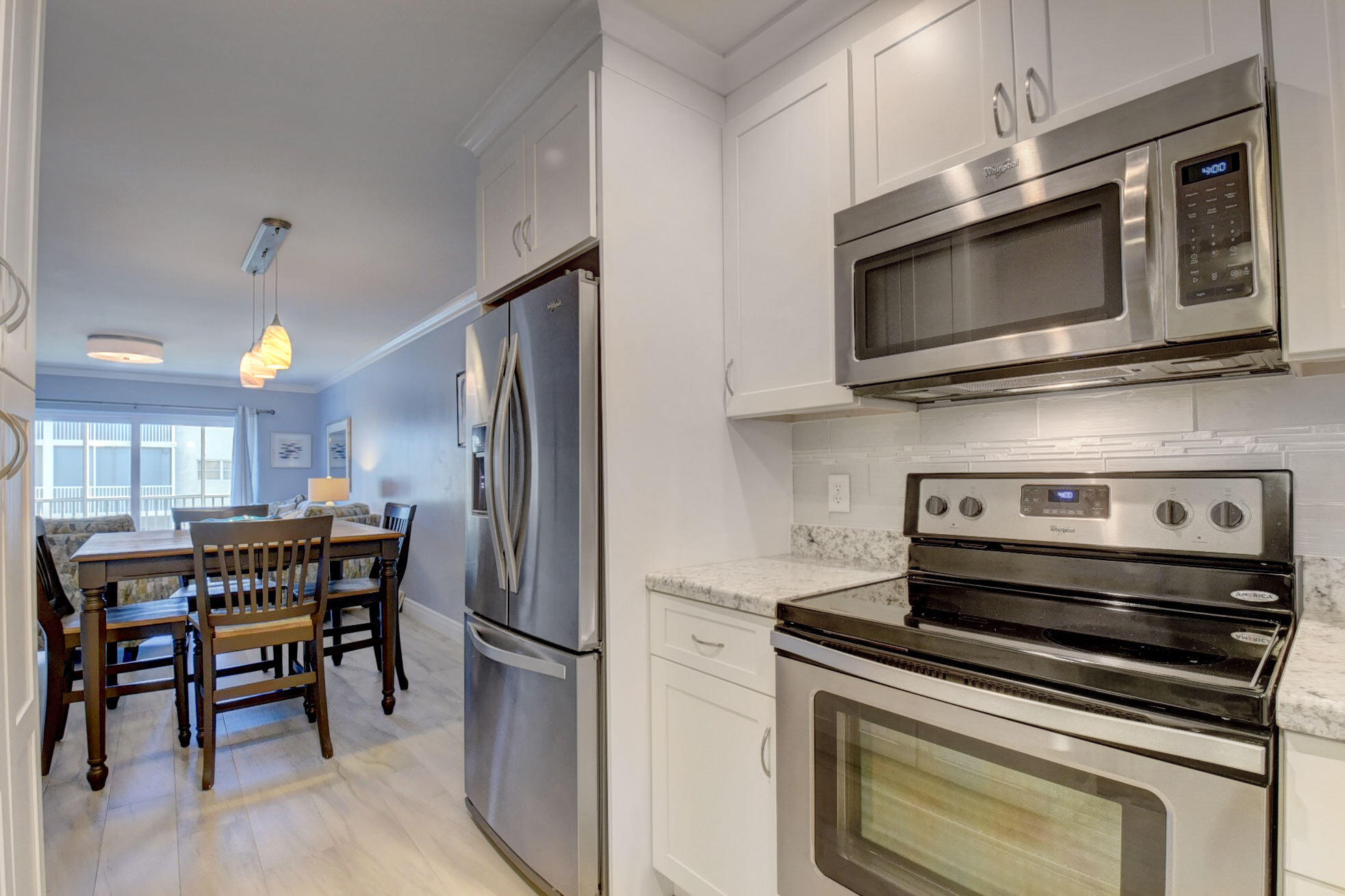 650 Snug Harbor Drive, Unit G307 Boynton Beach, FL 33435 - Photo 15 of 58 a kitchen with a stove and a microwave