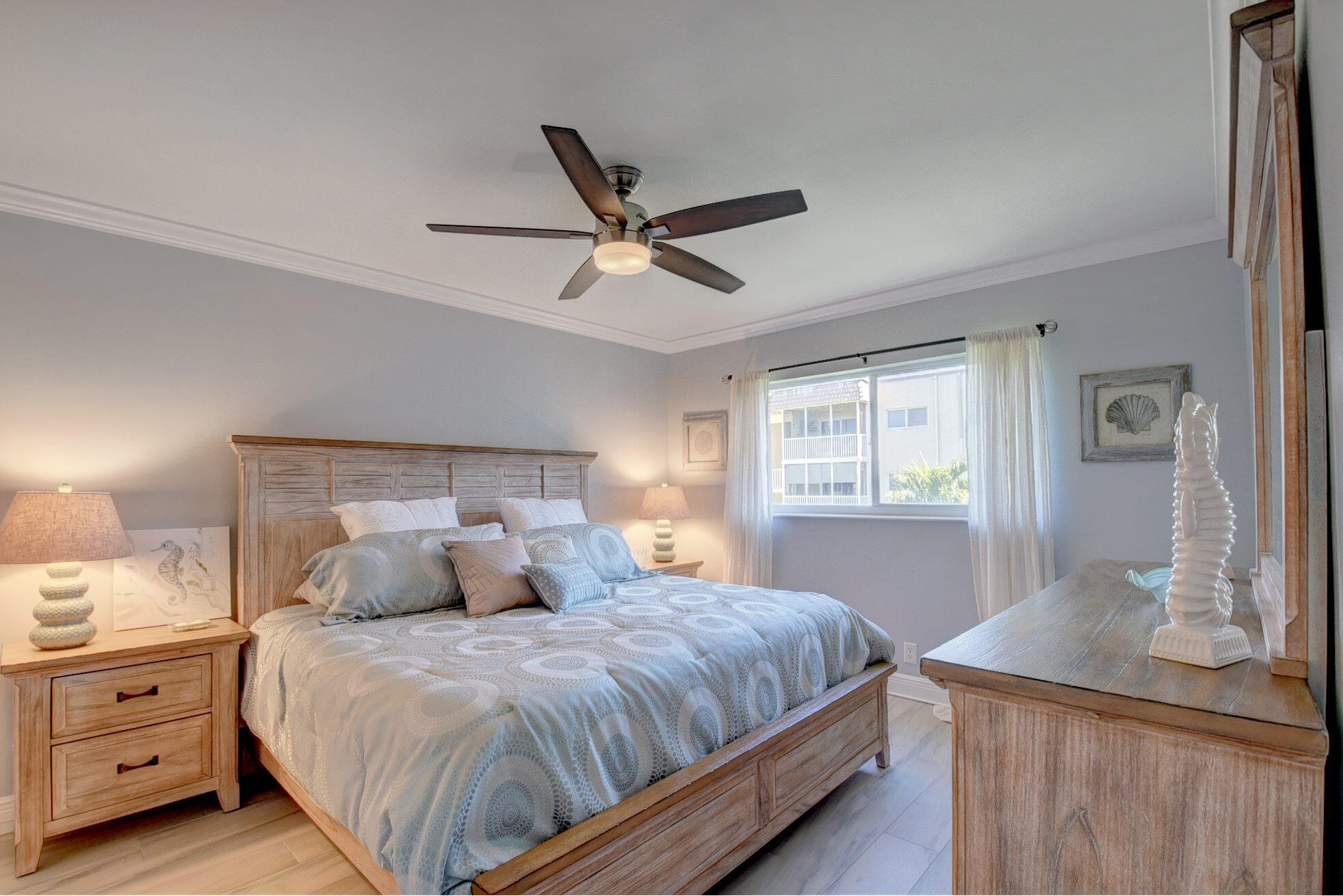 650 Snug Harbor Drive, Unit G307 Boynton Beach, FL 33435 - Photo 32 of 58 a bedroom with a large bed and a chandelier