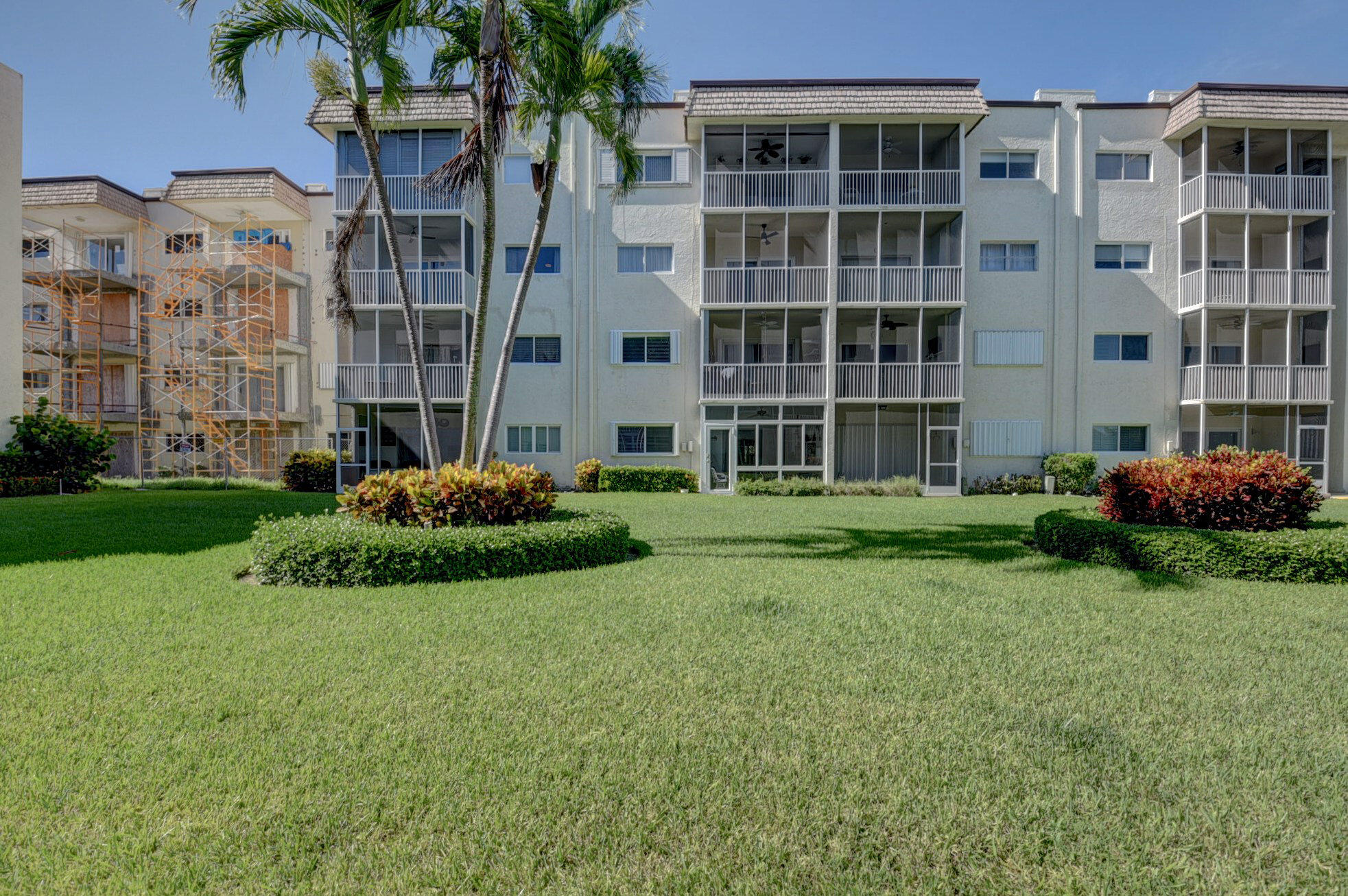 650 Snug Harbor Drive, Unit G307 Boynton Beach, FL 33435 - Photo 45 of 58 a garden with tall buildings in the background