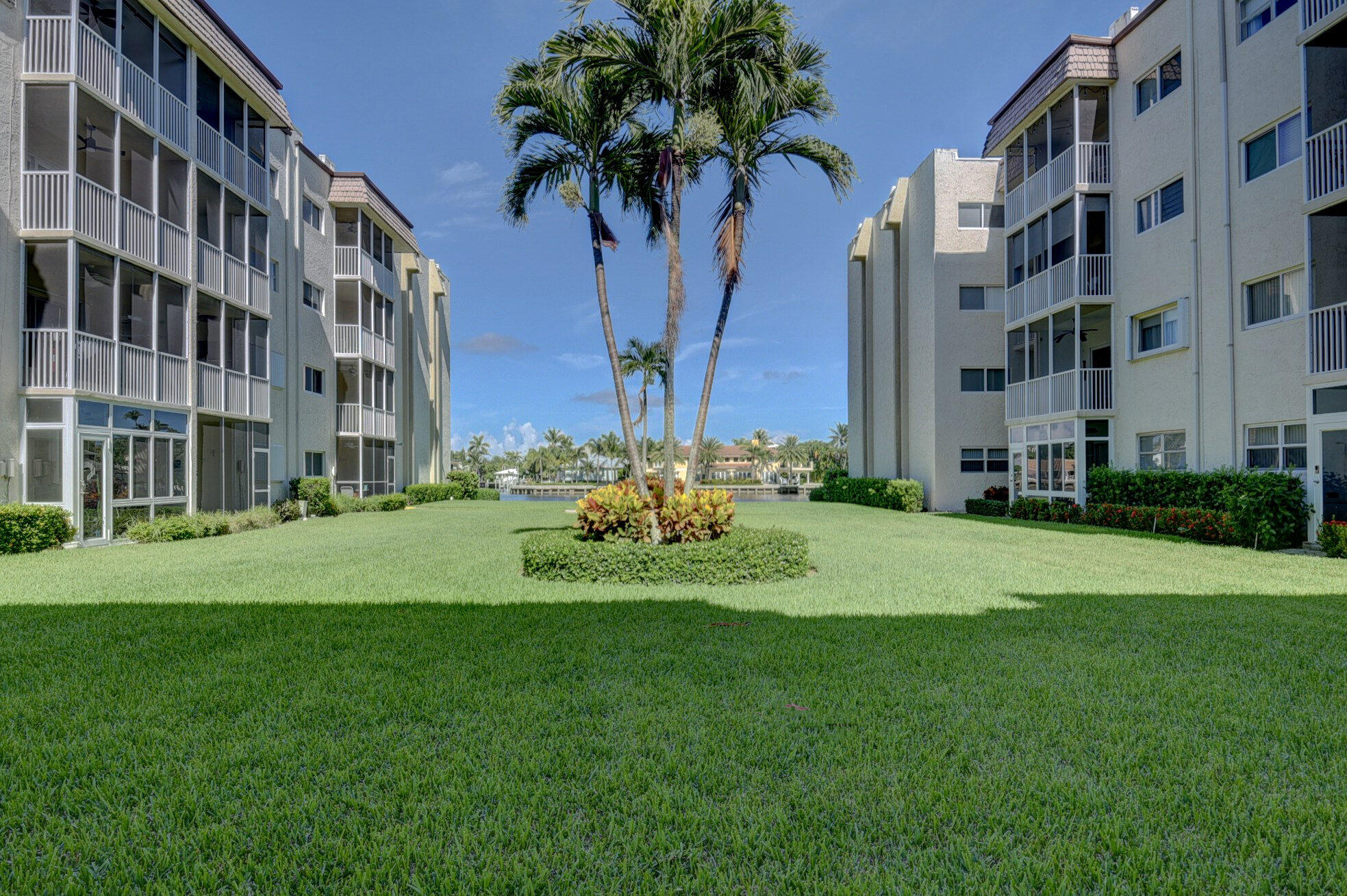 650 Snug Harbor Drive, Unit G307 Boynton Beach, FL 33435 - Photo 47 of 58 a view of a tall building with a yard