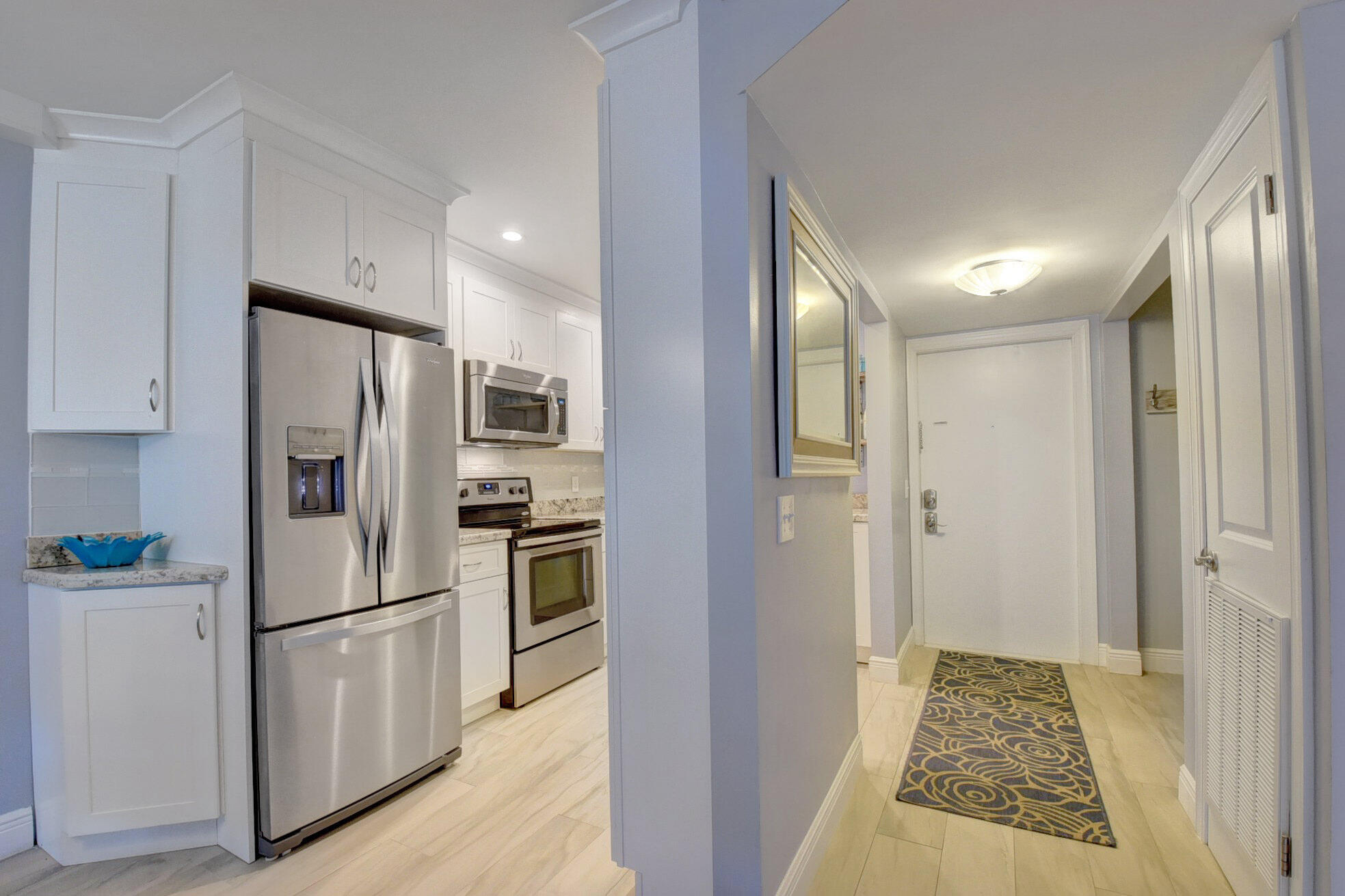 650 Snug Harbor Drive, Unit G307 Boynton Beach, FL 33435 - Photo 5 of 58 a kitchen with stainless steel appliances granite countertop a refrigerator and a stove