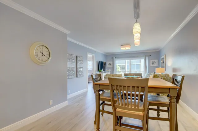 a view of a dining room with furniture and a large window