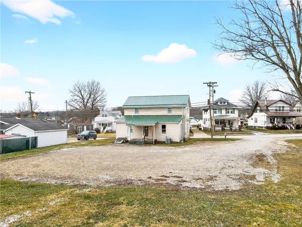 a view of a house with cars park