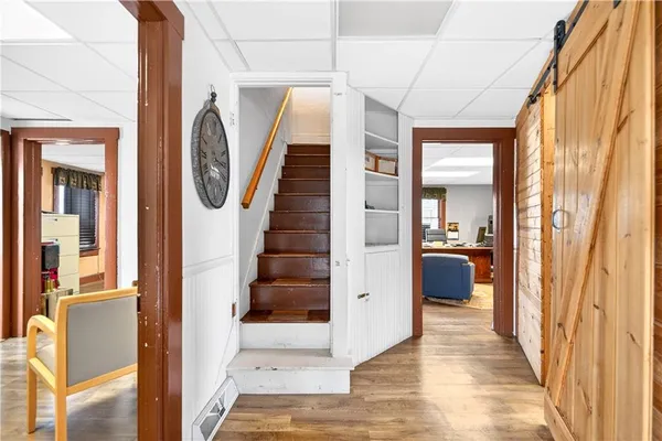 a view of a hallway with wooden floor and entryway