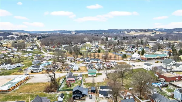 an aerial view of residential houses with city view
