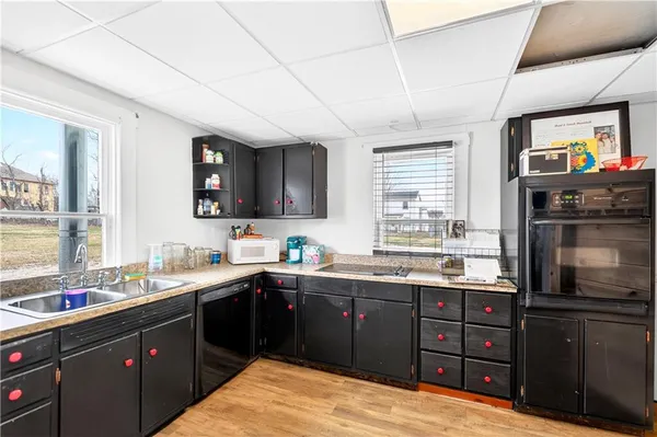 a kitchen with a sink stove and microwave
