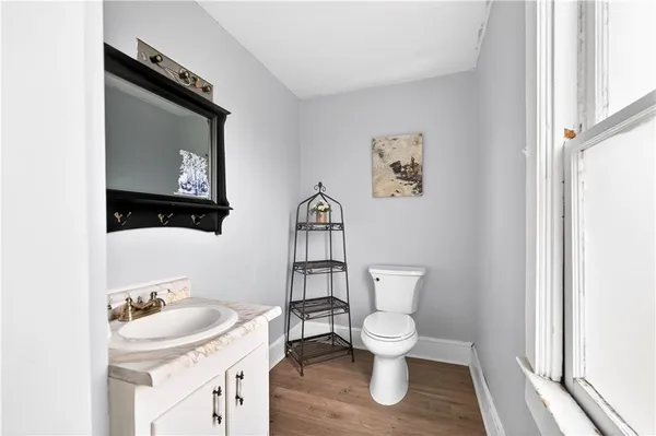 a bathroom with a toilet sink and mirror