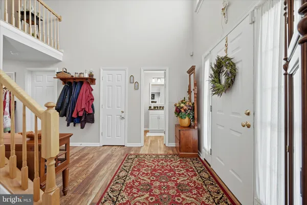 a view of a a dining room with furniture window and wooden floor