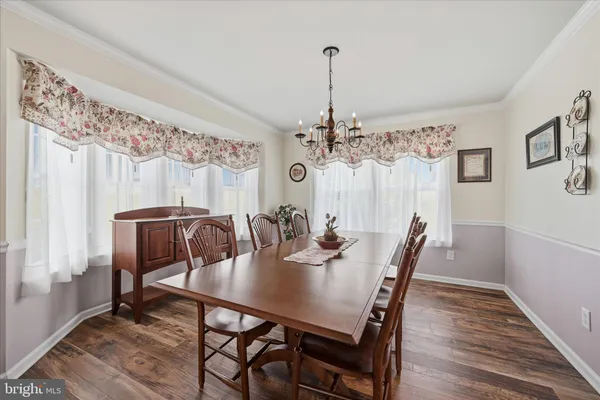 a kitchen with stainless steel appliances granite countertop a sink refrigerator and cabinets