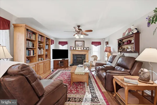 a bathroom with a granite countertop sink mirror vanity and toilet