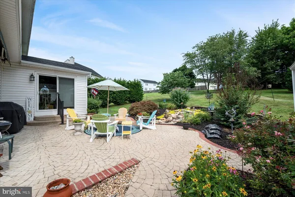 a view of a backyard with sitting area and garden
