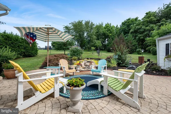 a view of a patio with couches chairs and a potted plant