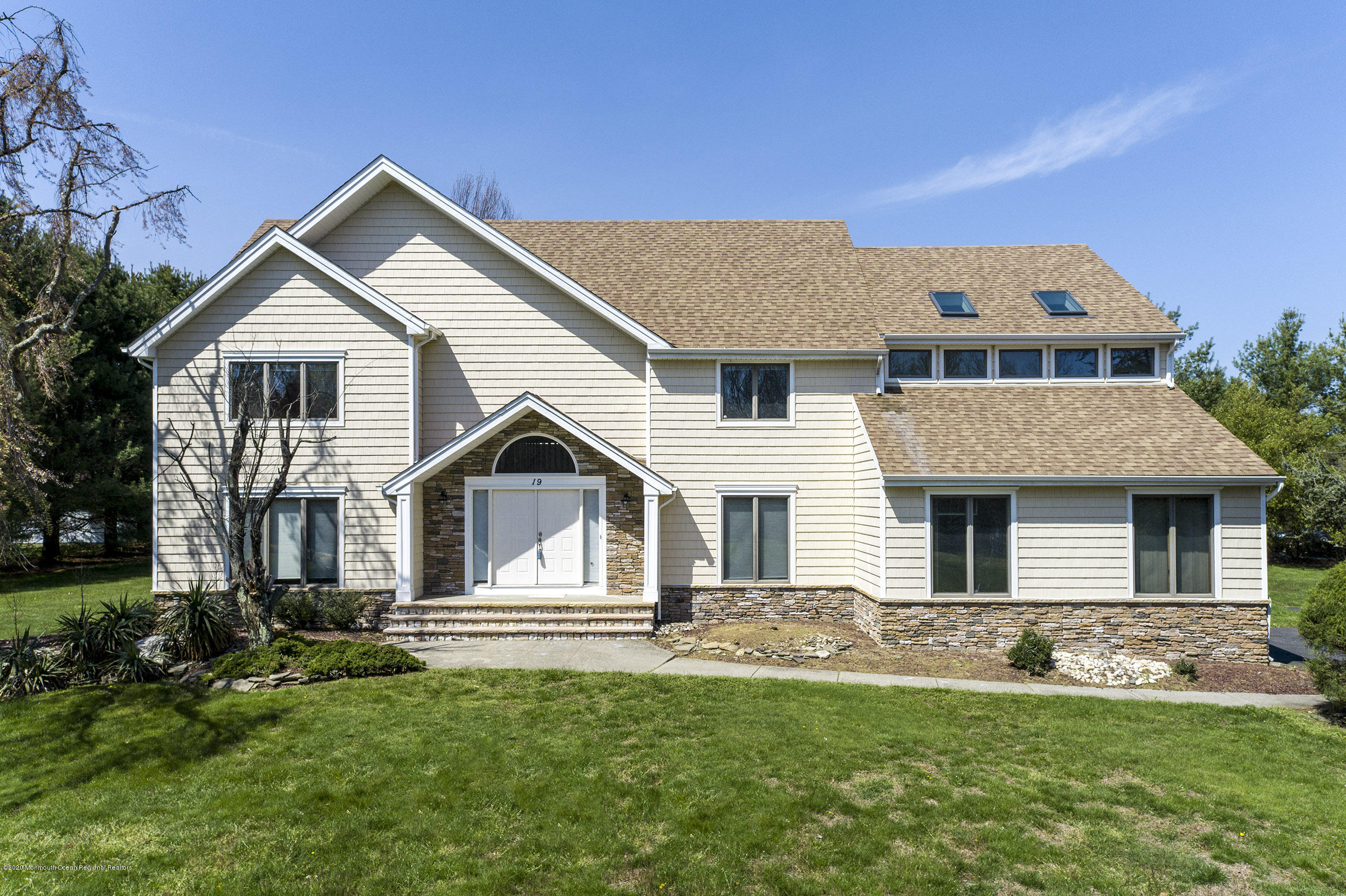 19 Riverside Lane Holmdel, NJ 07733 - Photo 1 of 40 a front view of a house with a garden and yard