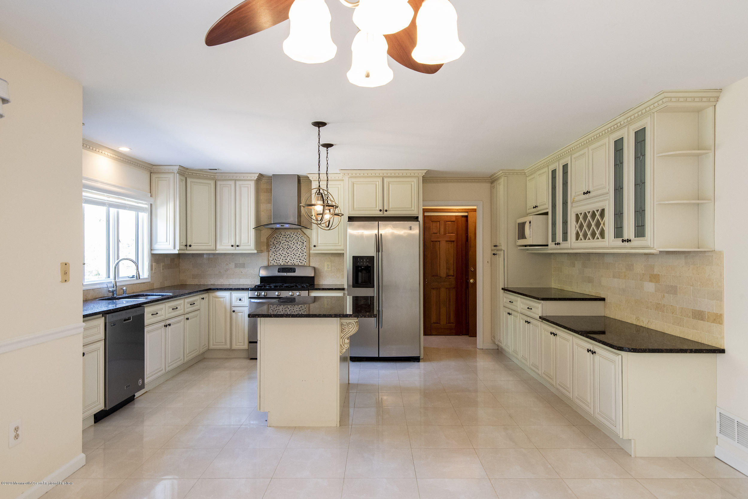 19 Riverside Lane Holmdel, NJ 07733 - Photo 3 of 40 a kitchen with stainless steel appliances granite countertop a sink and a stove