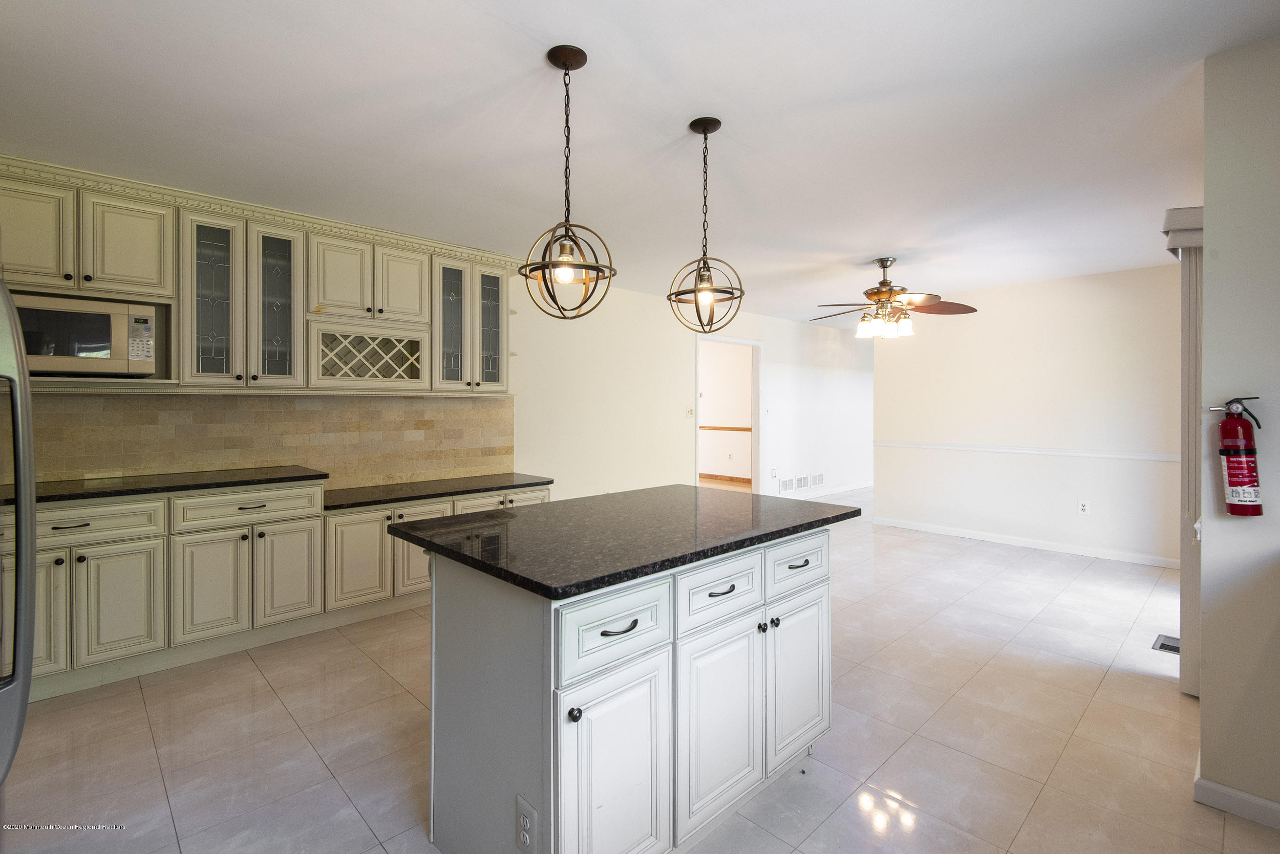 19 Riverside Lane Holmdel, NJ 07733 - Photo 4 of 40 a kitchen with stainless steel appliances granite countertop white cabinets and window