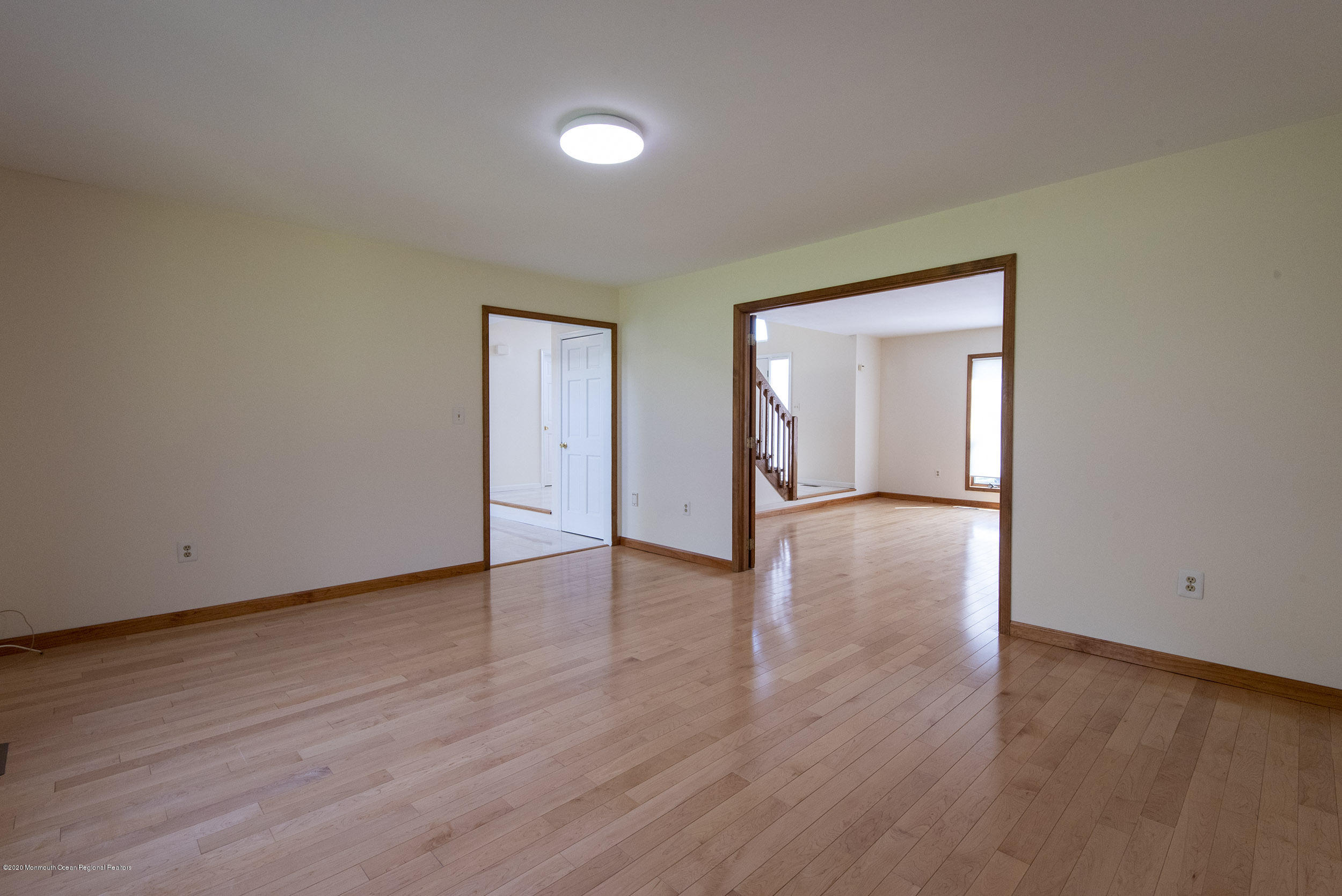 19 Riverside Lane Holmdel, NJ 07733 - Photo 10 of 40 a view of an empty room with wooden floor and a window