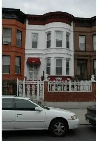 a view of a car parked in front of a house
