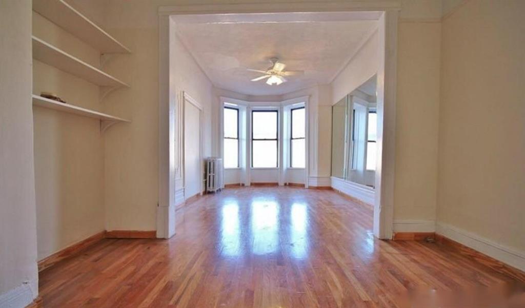 1595 Union Street Brooklyn, NY 11213 - Photo 2 of 21 an empty room with wooden floor and windows
