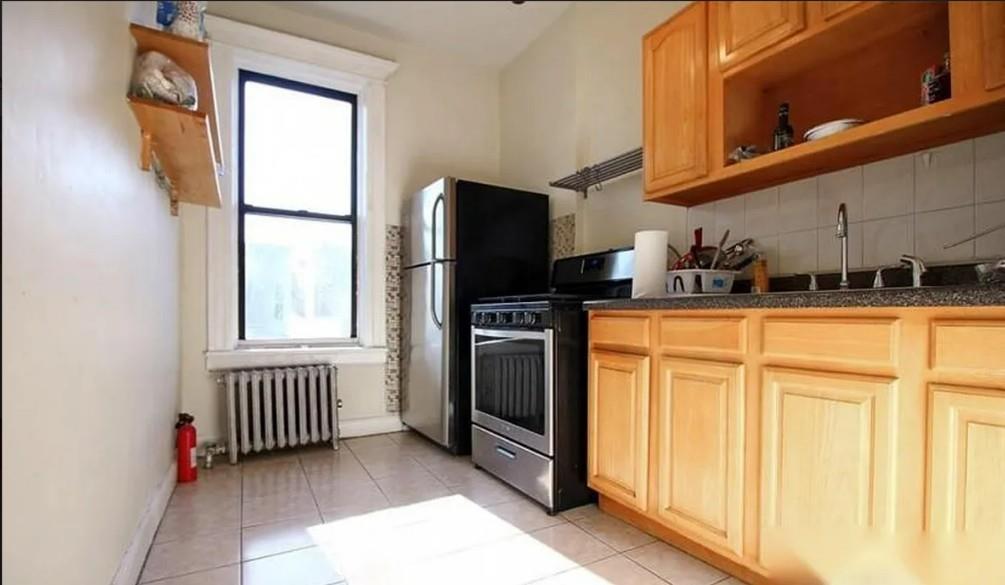 1595 Union Street Brooklyn, NY 11213 - Photo 5 of 21 a kitchen with stainless steel appliances granite countertop a refrigerator and a sink