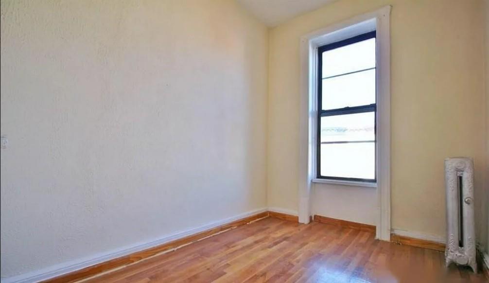 1595 Union Street Brooklyn, NY 11213 - Photo 6 of 21 an empty room with wooden floor and windows