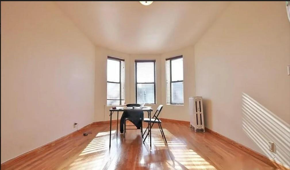 1595 Union Street Brooklyn, NY 11213 - Photo 9 of 21 a view of a room with wooden floor and a window