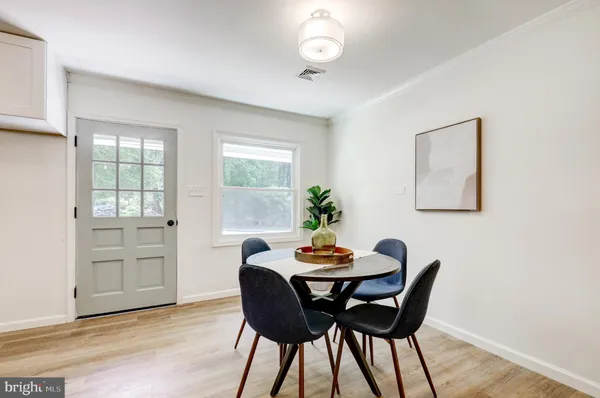a view of a dining room with furniture and window