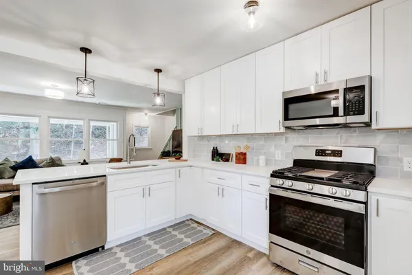 a kitchen with a sink stove and microwave