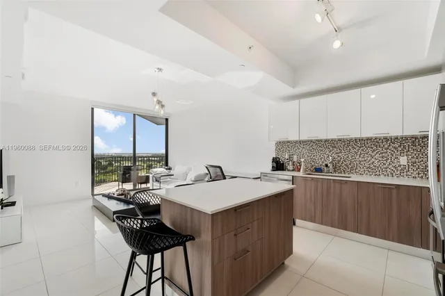 a kitchen with a table chairs sink and cabinets