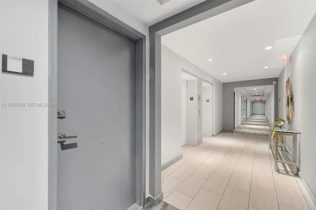 a view of a hallway with closet and chandelier