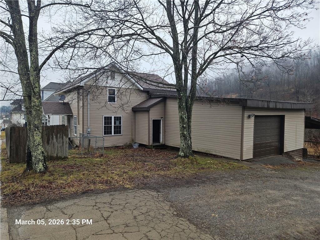 233 Main Street Bruin, PA 16022 - Photo 2 of 12 a view of a house with a large tree and a yard