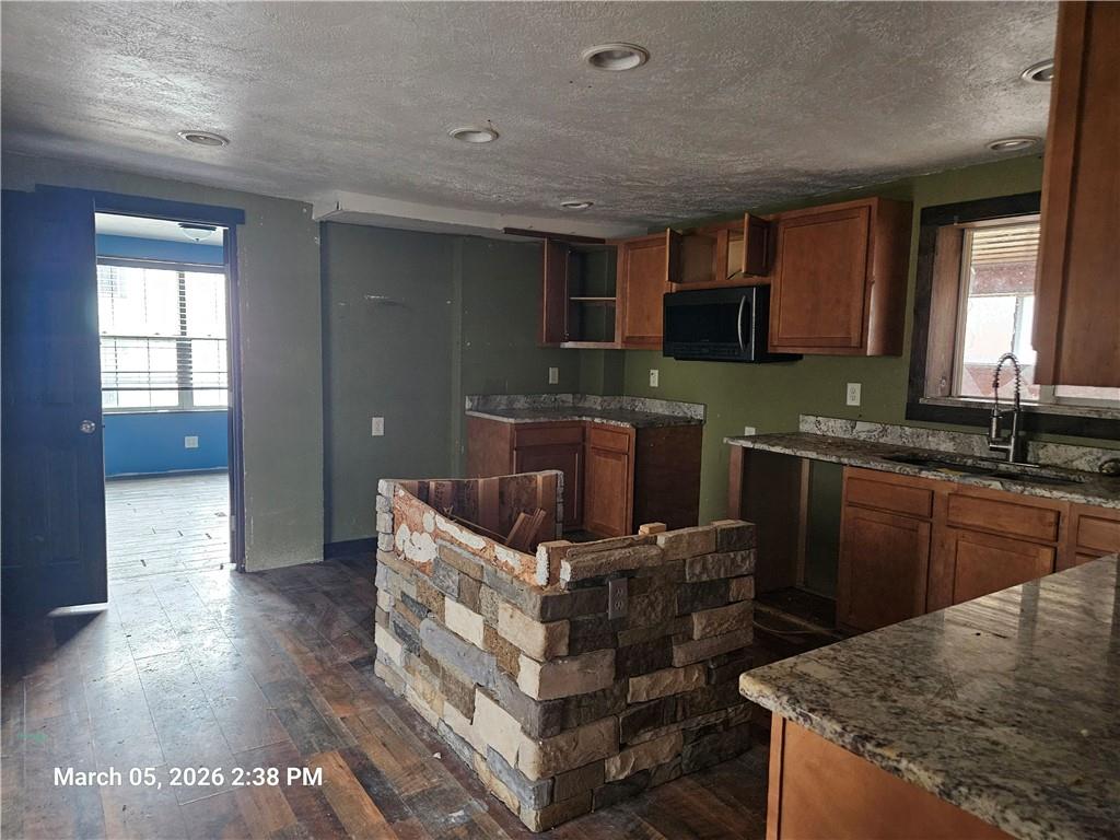 233 Main Street Bruin, PA 16022 - Photo 3 of 12 a kitchen with granite countertop a sink and a stove