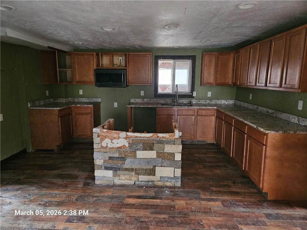 233 Main Street Bruin, PA 16022 - Photo 4 of 12 a kitchen with stainless steel appliances granite countertop wooden cabinets a stove top oven a sink and dishwasher