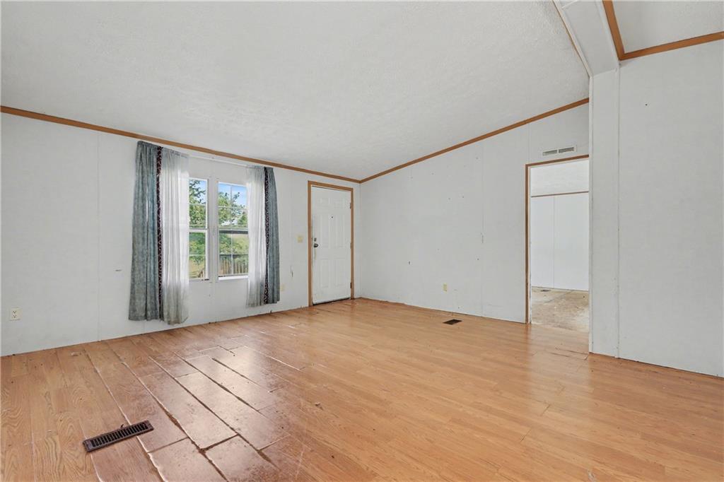 249 John Golden Road Temple, GA 30179 - Photo 16 of 45 a view of an empty room with wooden floor and a window