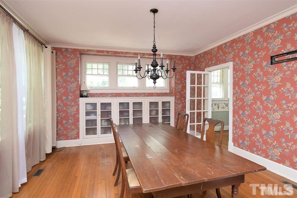 225 Hillcrest Road Raleigh, NC 27605 - Photo 5 of 18 a view of a dining room with furniture window and wooden floor