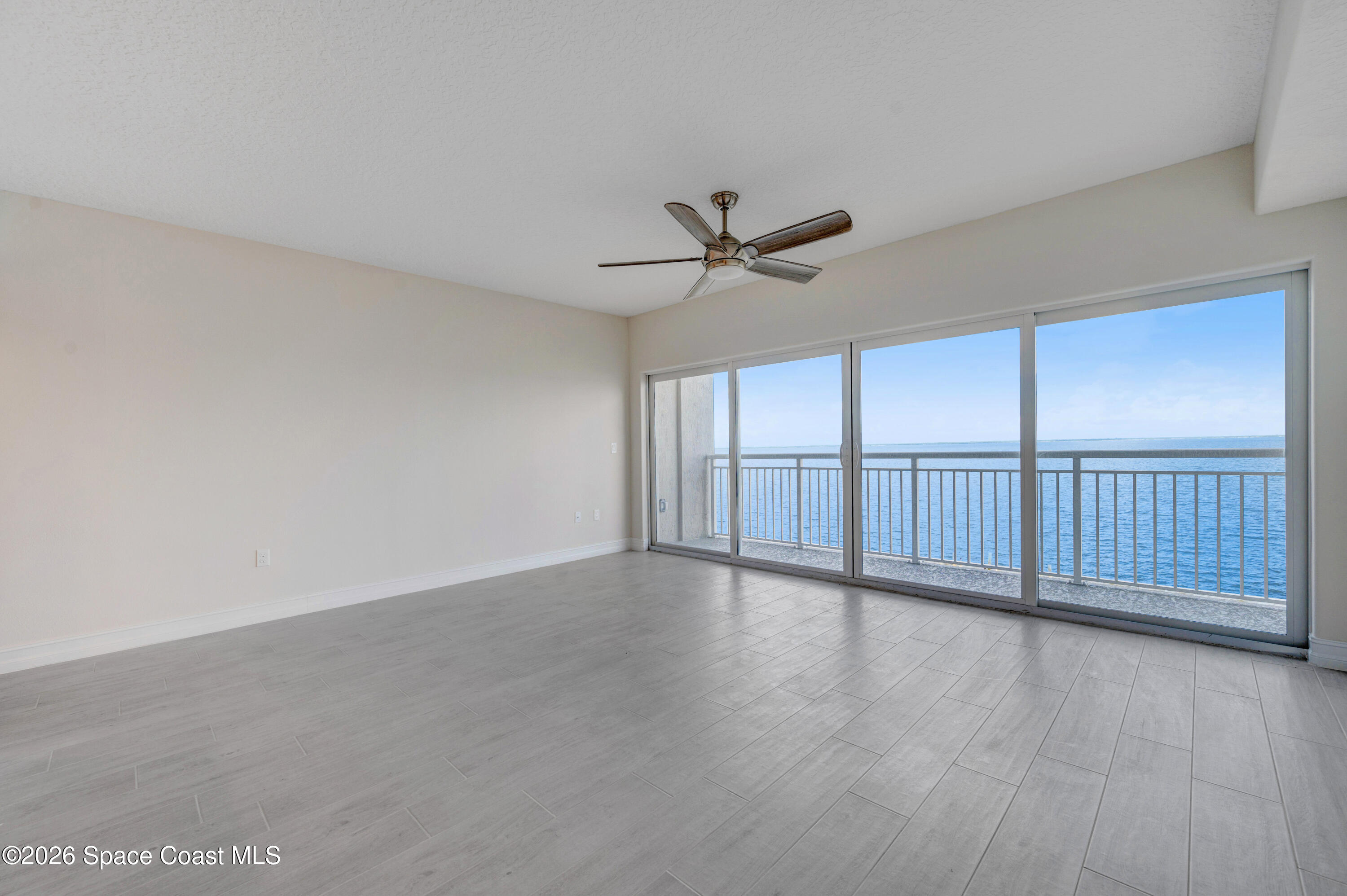 1805 Riverside Drive, Unit 304 Titusville, FL 32780 - Photo 28 of 46 a view of an empty room with wooden floor and a window