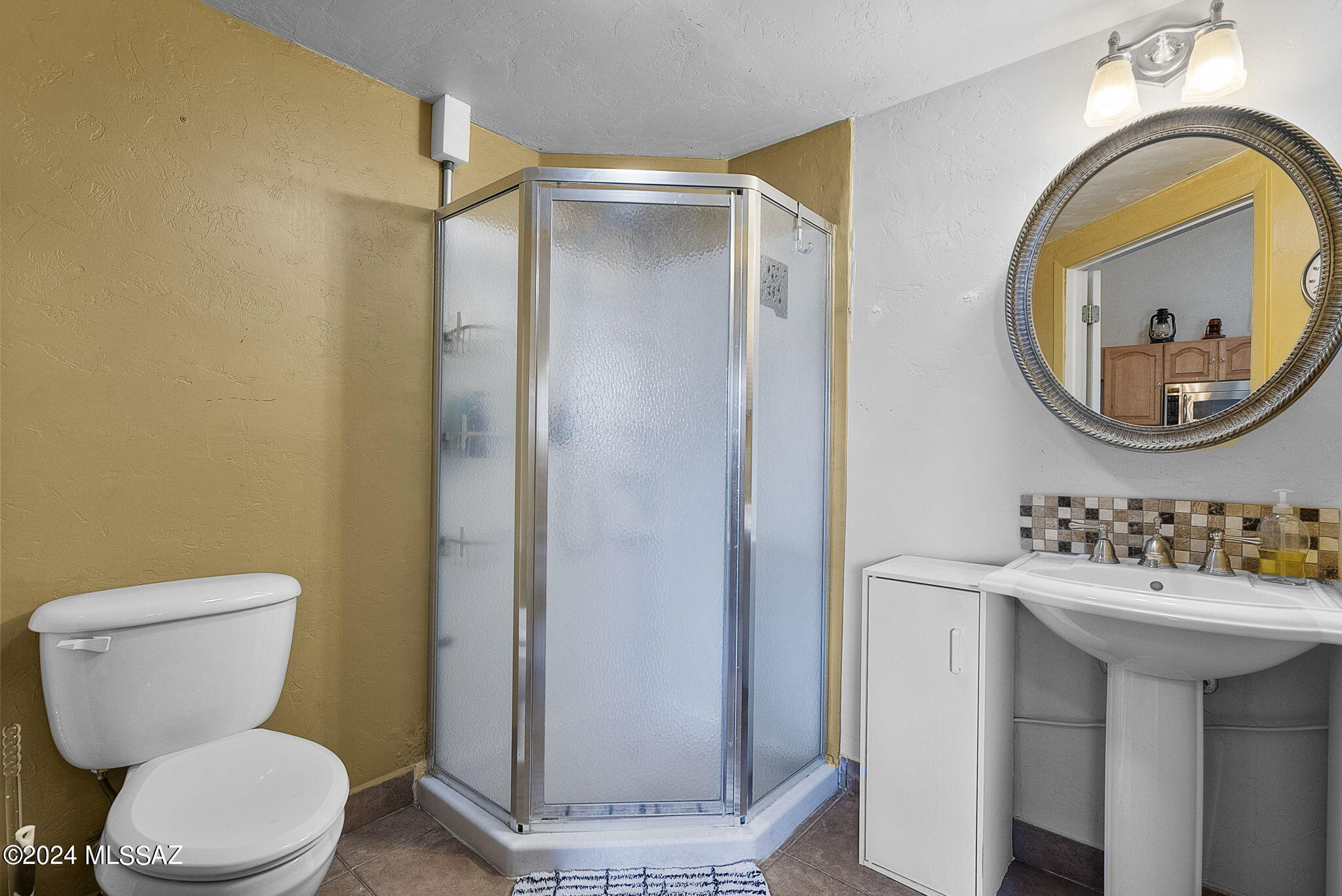 22 Vigas Lane Rio Rico, AZ 85648 - Photo 27 of 40 a bathroom with a toilet sink and a mirror